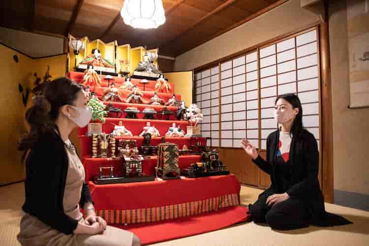 Hamasaki in conversation with the author in front of Hina dolls that Japanese households exhibit in March to celebrate the growth of their girls